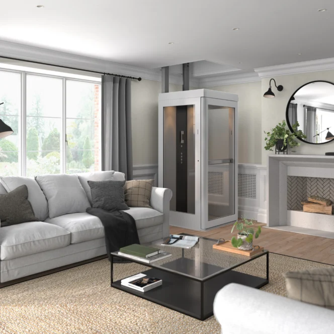 A modern living room with a white sofa, glass coffee table, and a small residential elevator near the fireplace. Large windows let in natural light.
